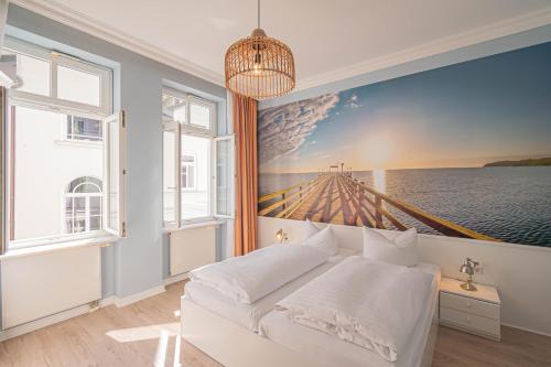 a bedroom with a large painting on the wall at Villa Baltik in Binz