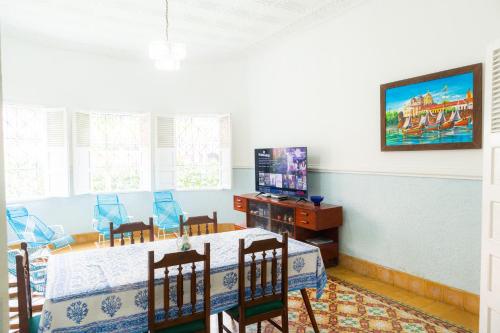 a dining room with a table and a television at Casa Colonial en Manga in Cartagena de Indias