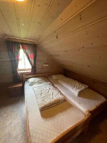a room with two beds in a log cabin at Kvam - Stegastein in Aurland