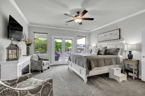 a bedroom with a bed and a ceiling fan at Stunning Luxury Lake Home with Waterfront & Dock! in Horseshoe Bay