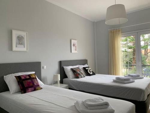 a bedroom with two beds and a window at Seas the Day in Preveza