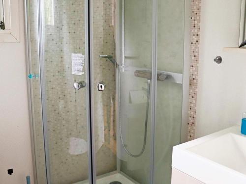 a shower with a glass door in a bathroom at Holiday home STENINGE in Steninge