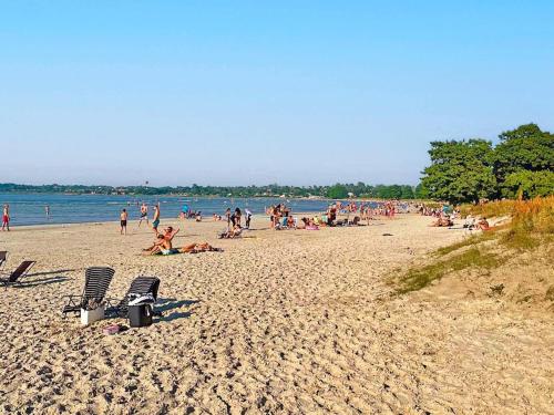 a group of people sitting on a beach at 5 person holiday home in BORGHOLM-By Traum in Borgholm