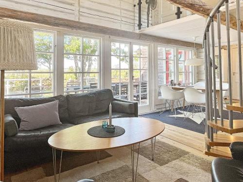 a living room with a couch and a table at 5 person holiday home in BORGHOLM-By Traum in Borgholm