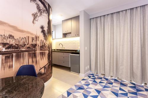 a kitchen and dining room with a table and blue chairs at Travel Inn Paulista Wall Street in Sao Paulo