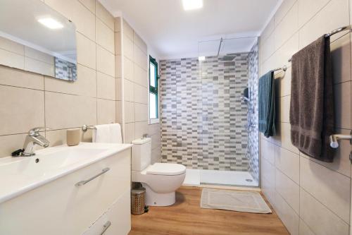 a bathroom with a toilet and a sink and a shower at Relaxing Apartment with Ocean Views in Puerto Rico de Gran Canaria