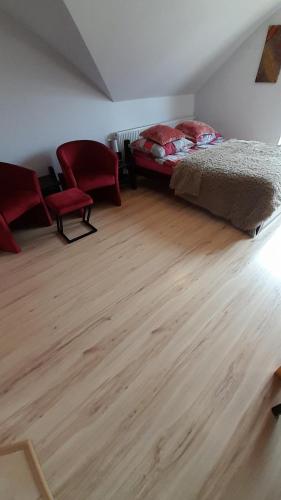 a bedroom with a bed and a wooden floor at Willa Gracja in Wisła