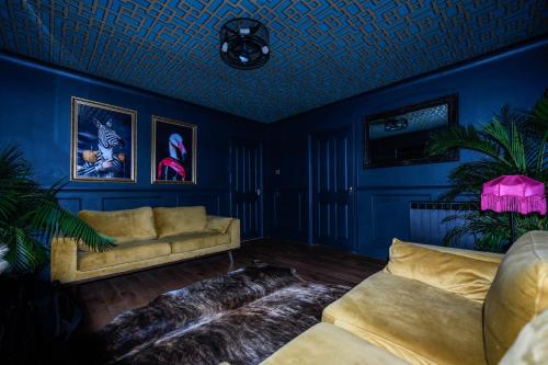 a living room with blue walls and a couch at South coast boudoir in Bognor Regis