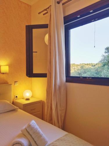 a bedroom with a bed and a large window at Meraki apartment in Zenempisátika