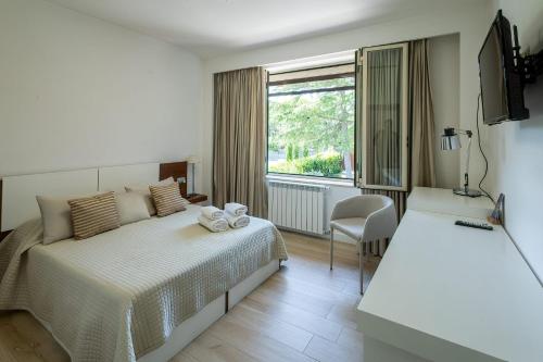 Voodi või voodid majutusasutuse Villa dei Tigli Resort & SPA toas