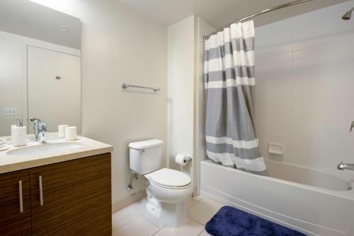 a bathroom with a toilet and a sink and a shower at Lower Nob Hill Studio w Gym WD AC nr CPMC SFO-116 in San Francisco