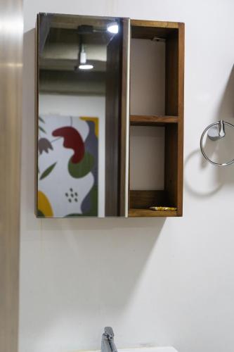 a cabinet with a mirror above a sink at M1145 Aparta Loft in Pereira
