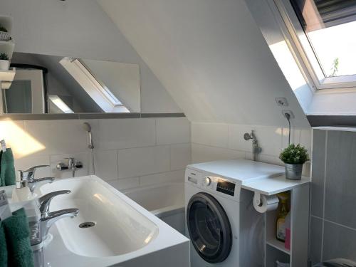 a bathroom with a washing machine and a sink at 5 Sterne Monteurwohnung, Ferienwohnung, mit Wallbox TOP Möbliert in Greven