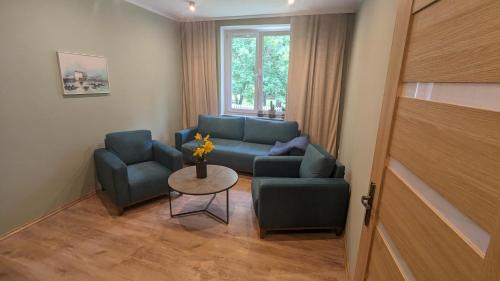 a living room with a couch and two chairs and a table at Zielono mi....... in Jelenia Góra