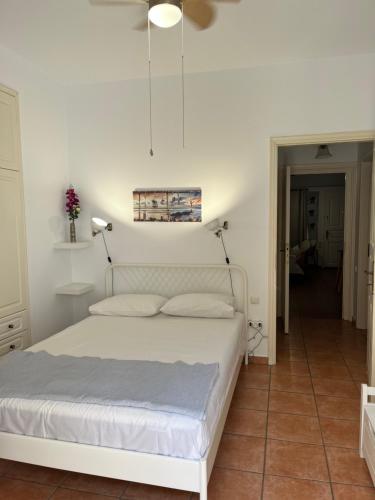 a bedroom with a white bed in a room at Theoni's Village Apartment II in Kalamata