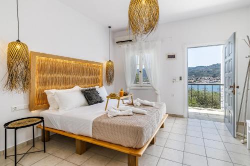 a bedroom with a bed with a wooden headboard at Ourania Studios & Apartments in Skopelos Town
