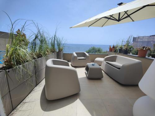 a row of chairs and tables on a balcony at Luxury B&b Euphorbia in Acireale