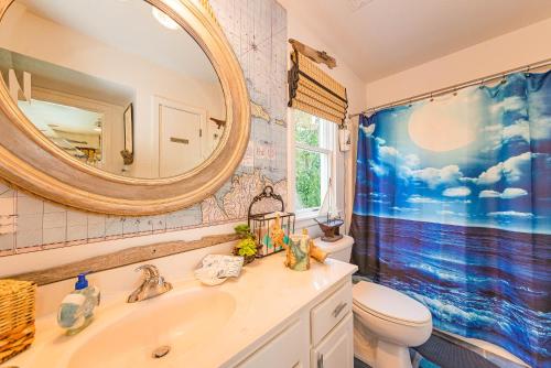 a bathroom with a sink and a toilet and a mirror at Simple Gifts by the Sea in Duck