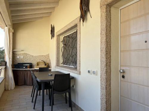 a dining room with a table and chairs at Antica Fonte Holiday Homes in San Pantaleo