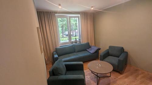 a living room with a couch and two chairs and a table at Zielono mi....... in Jelenia Góra