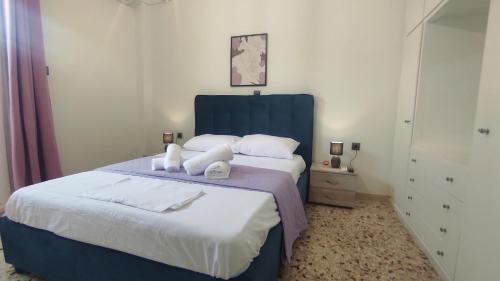 a bedroom with a blue bed with towels on it at City Apartment w3 BR spacious yard in Eretria