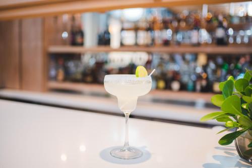 a martini glass with a lime on top of a counter at Hotel Los Portales in Chinandega