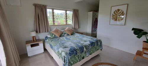 a bedroom with a bed and a window at Serene Holiday Home in Rarotonga