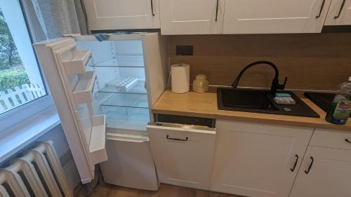 a refrigerator with its door open in a kitchen at Zielono mi....... in Jelenia Góra