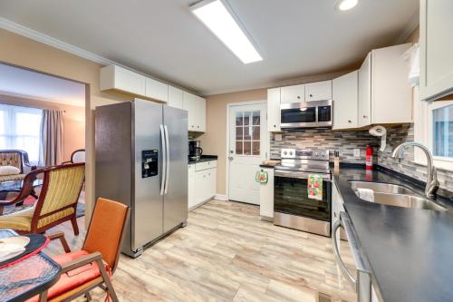 a kitchen with stainless steel appliances and a dining room at Cozy North Carolina Retreat Near Beaches and Golfing in Jacksonville