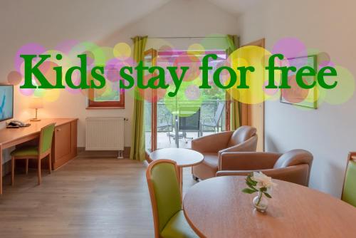 a kids stay for free sign in a waiting room at Hotel Bayerischer Wald in Neukirchen