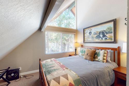 a bedroom with a large bed and a window at Bass Lake Lodge in Bass Lake