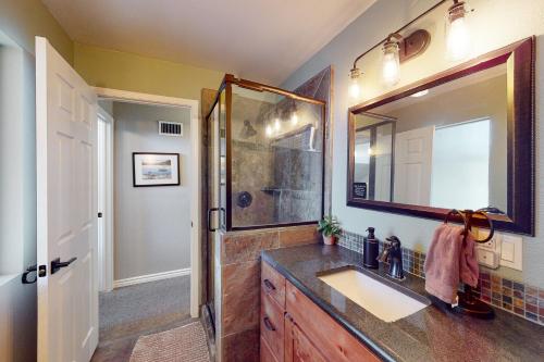 a bathroom with a sink and a shower at Bass Lake Lodge in Bass Lake