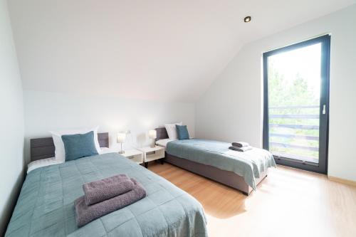 Katil atau katil-katil dalam bilik di Apartamenty Literówka