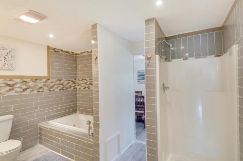 a bathroom with a shower and a toilet and a tub at Renovated Louisiana Rental Near Mississippi River 