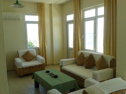 a living room with a couch and a table at Orange Grove Apart Hotel in Alanya