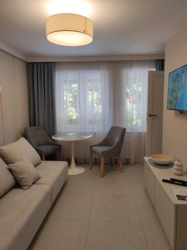 a living room with a couch and a table at Sileo Apart No.85 in Ustka
