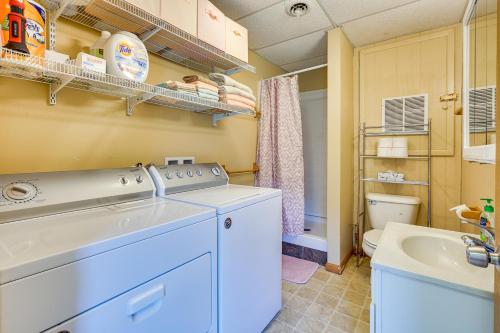 a laundry room with a washing machine and a sink at Quaint Somerset Getaway with Fire Pit! in Mount Perry