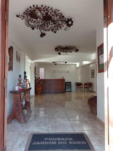 a large room with a lobby with a table and chairs at Pousada Jardim do Éden in Serra do Cipo