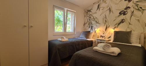 Ένα ή περισσότερα κρεβάτια σε δωμάτιο στο Apartments Hvaranin
