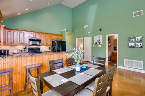 a dining room with a table and a kitchen at Fish and Kayak Tranquil Cedar Creek Home! in Tool