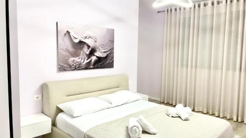 um quarto com duas camas e um quadro na parede em Lovely Apartment em Tirana