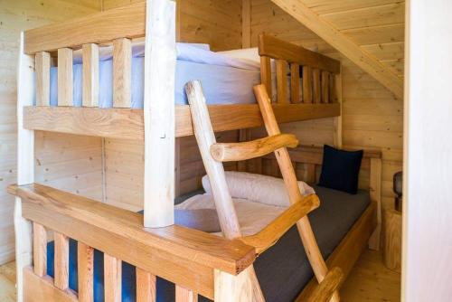 a wooden bunk bed in a log cabin at Beskid Wood Houses in Jasnowice