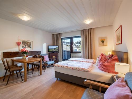 a bedroom with a bed and a dining room at Appartementhaus Mantl in Westendorf