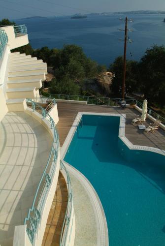 a swimming pool with a view of the ocean at Liberty - Classic luxury sea view villa with private pool, Panoramic views to Kommeno & Corfu old Town in Kommeno