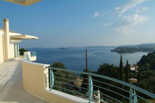 a balcony with a view of a body of water at Liberty - Classic luxury sea view villa with private pool, Panoramic views to Kommeno & Corfu old Town in Kommeno