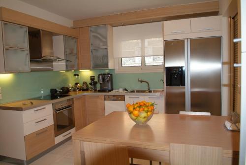 a kitchen with a bowl of fruit on a table at Liberty - Classic luxury sea view villa with private pool, Panoramic views to Kommeno & Corfu old Town in Kommeno