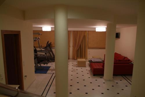 a living room with a couch and a gym at Liberty - Classic luxury sea view villa with private pool, Panoramic views to Kommeno & Corfu old Town in Kommeno