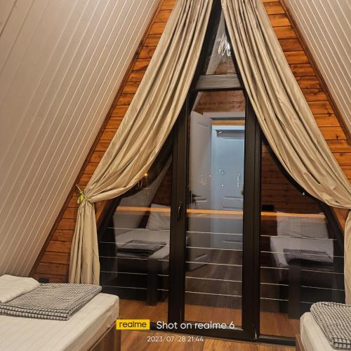 a room with a window in a tiny house at B&B Cottage in Mestia in Mestia