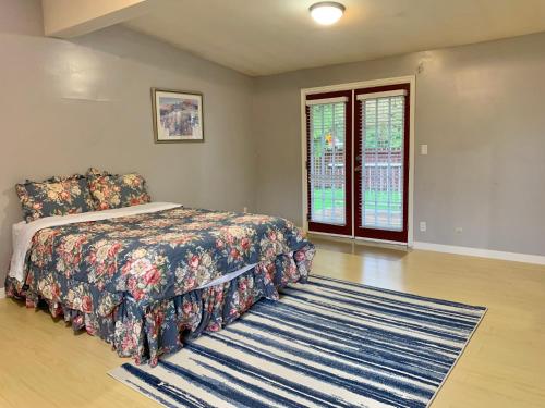 a bedroom with a bed and a rug at Whole Suite to Yourself at Coquitlam Centre! in Port Coquitlam