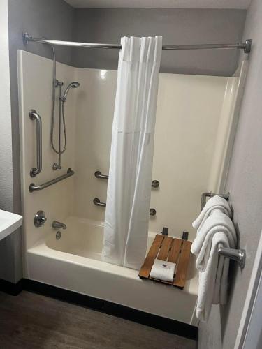 a bathroom with a shower with a shower curtain at Motel 6-Lakeland, FL in Lakeland